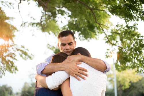Undocumented Latino Father Hugging his Two Children - Ashley Wood Law, P.C.