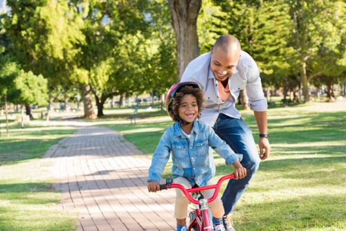 Happy Divorced Dad and Child on Bike - Ashley Wood Law, P.C.