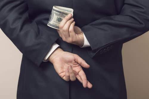 Man Hiding Money Behind his Back - Ashley Wood Law, P.C.