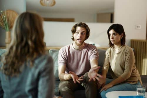 Young couple discussing if divorce mediation is for their family law or divorce situation with an attorney.
