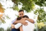 Undocumented Latino Father Hugging his Two Children - Ashley Wood Law, P.C.