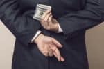 Man Hiding Money Behind his Back - Ashley Wood Law, P.C.