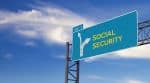 Large green highway sign with arrow to social security - Ashley Wood Law, P.C.